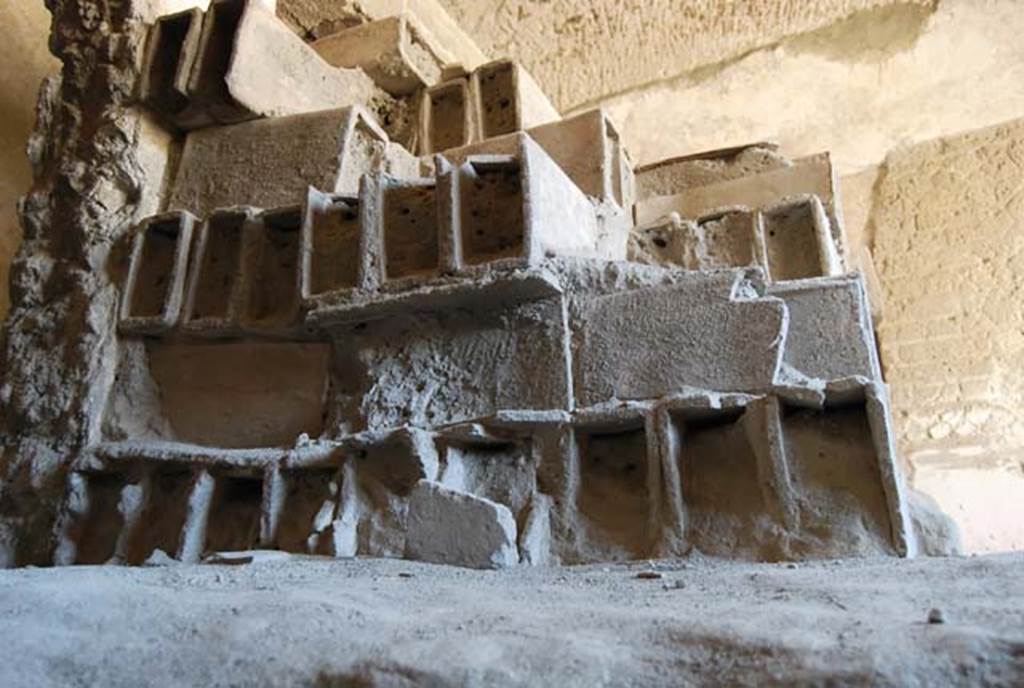 Suburban Baths, Herculaneum, April 2008. Terracotta tubes stacked in the Baths, and still awaiting installation as heating flues, completely filled with the dense ash from the pyroclastic flows. Photo courtesy of Nicolas Monteix.